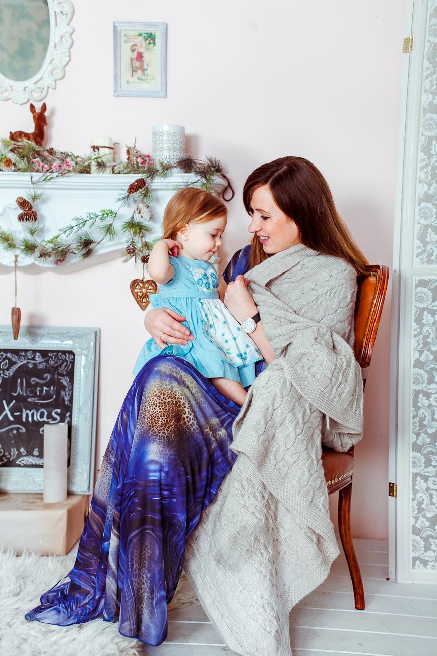 mother and child sitting on a wooden chair